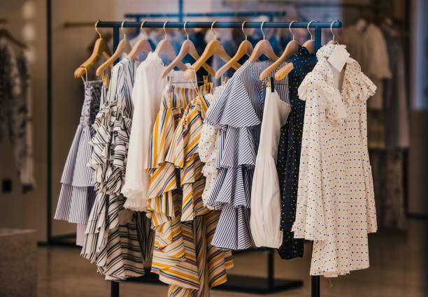 Rack of women's clothing with various styles and colors in a store setting.